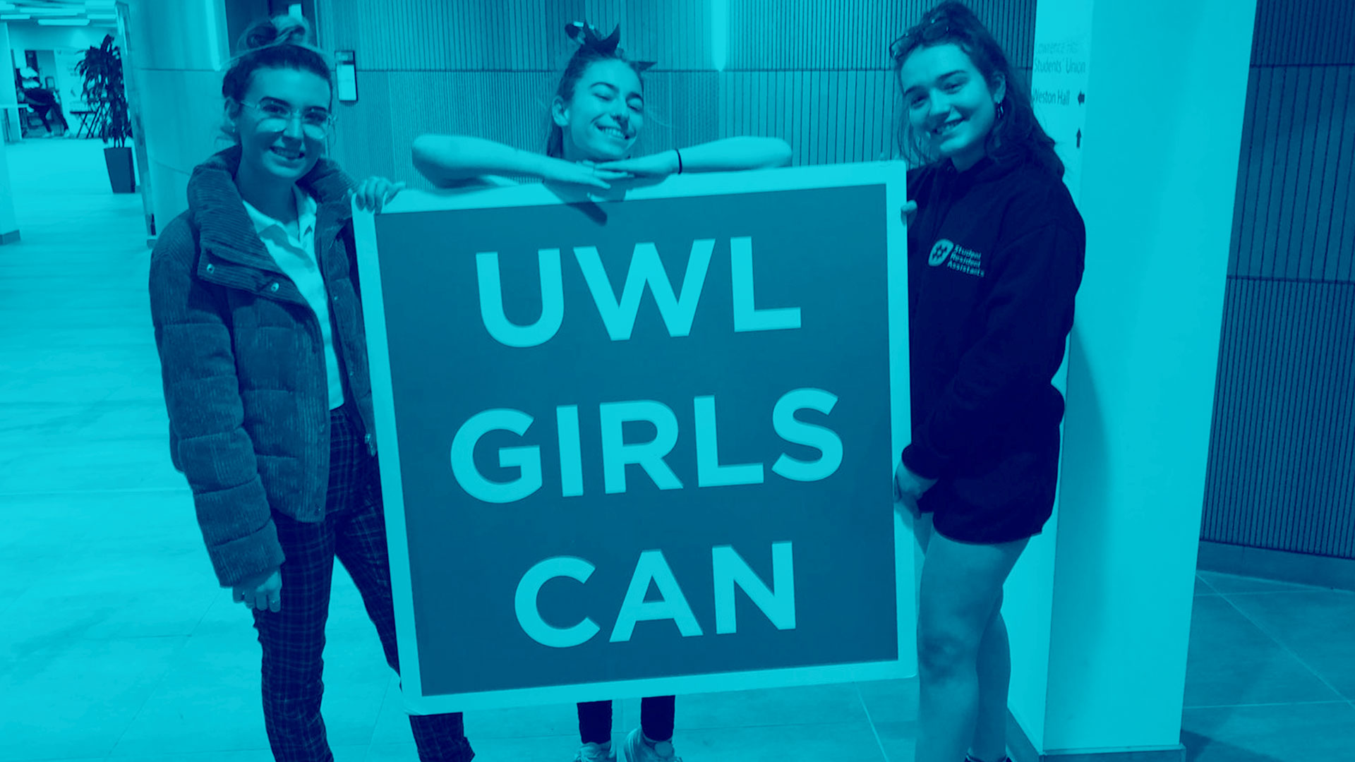 Student Group holding UWL Girls Can sign