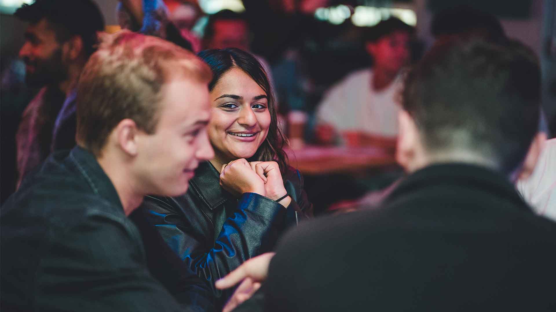 A student smiling at the UWLSU Quizz event